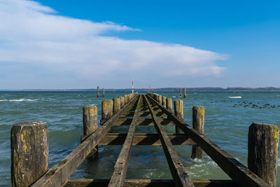 Pier over sea against sky