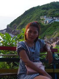 Portrait of smiling young woman on land