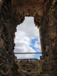 Low angle view of historic building seen through hole