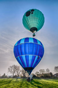 Hot air balloon flying over field