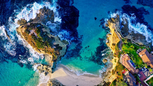 High angle view of rock formations by sea