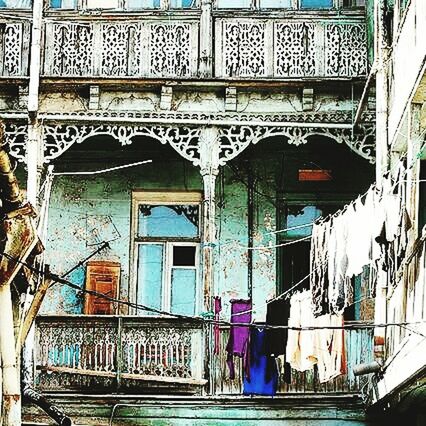 architecture, built structure, building exterior, railing, window, building, low angle view, staircase, steps, art and craft, day, indoors, entrance, art, balcony, arch, no people, house, architectural feature, residential structure