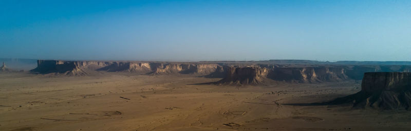 Panoramic view of desert against clear sky