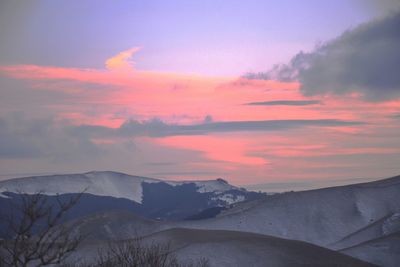 Scenic view of mountains against sky at sunset