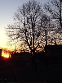 Silhouette bare trees against sky at sunset