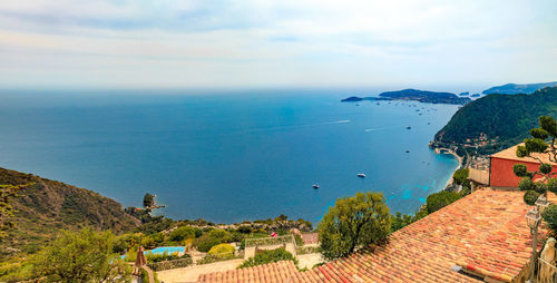 High angle view of townscape by sea against sky