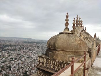 Ancient temple against sky in city