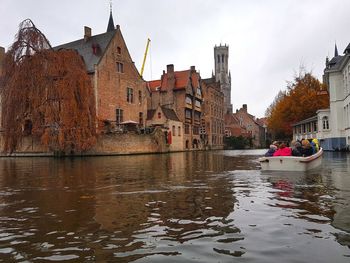 Boats in river with buildings in background