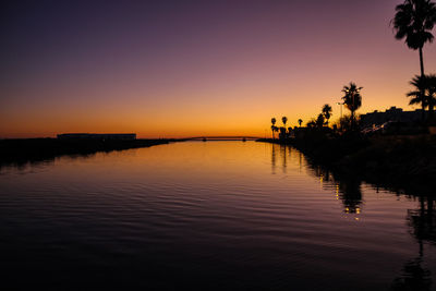 Scenic view of lake against romantic sky at sunset