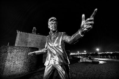 Low angle view of statue against sky at night