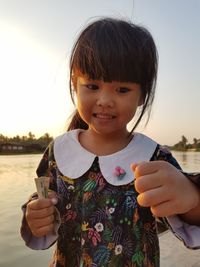 Portrait of cute girl holding camera