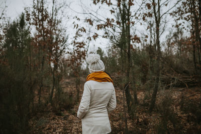 Rear view of man standing in forest