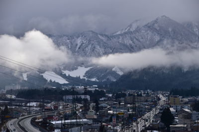 High angle view of snowcapped mountains against sky