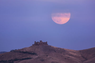 Scenic view of mountain against clear sky at night
