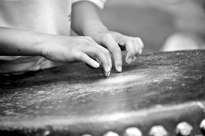 Midsection of woman touching musical instrument