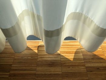 High angle view of curtain above floorboard at home