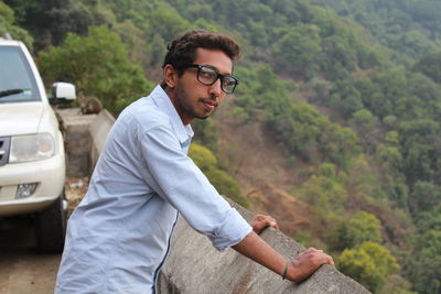 Portrait of young man standing at observation point