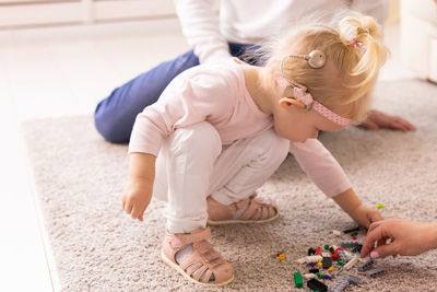 High angle view of boy playing with toy at home