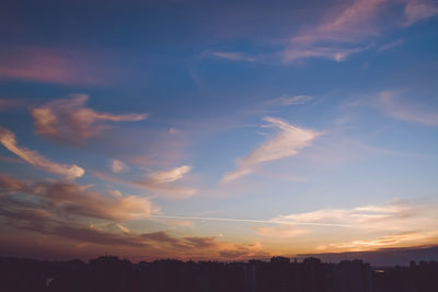 Silhouette buildings against sky during sunset