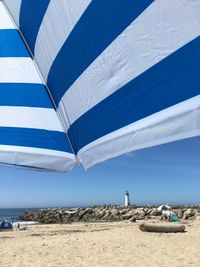 Scenic view of beach against blue sky