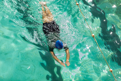 High angle view of man swimming in pool