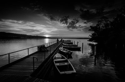 Wooden jetty in sea against sky