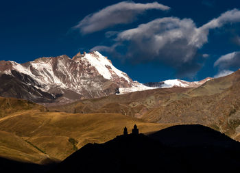 Scenic view of silhouette mountains against sky