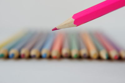 Close-up of colored pencils against white background