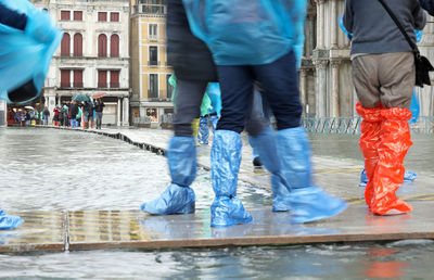 Low section of people on wet street in rainy season