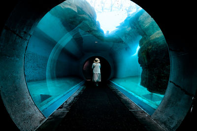 Rear view of man standing in tunnel