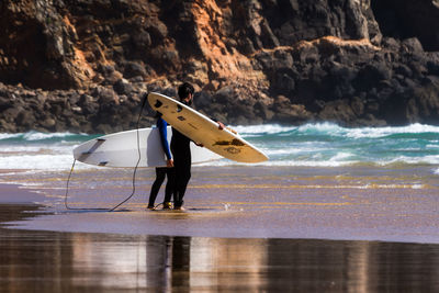 Man in sea against sky