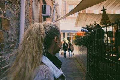 Side view of woman on street in city