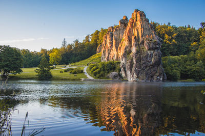 Scenic view of lake by trees against clear sky