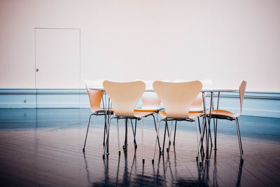 Empty chairs and table in water