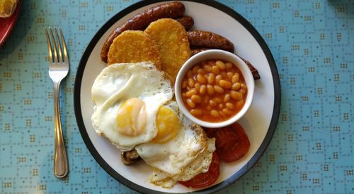 Plate of english breakfast on table