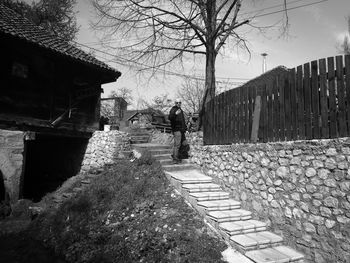 People walking on footpath by building