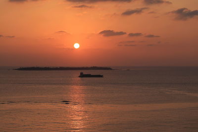 Scenic view of sea against orange sky