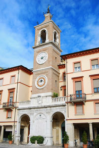 Low angle view of clock tower against sky