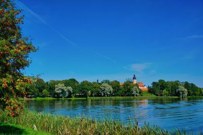 Scenic view of lake against blue sky