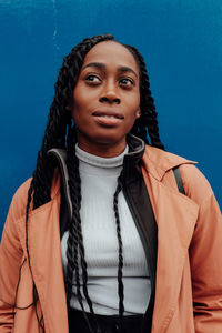 Portrait of woman against blue background