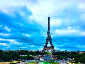 Tower of building against cloudy sky