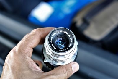 Close-up of human hand holding camera