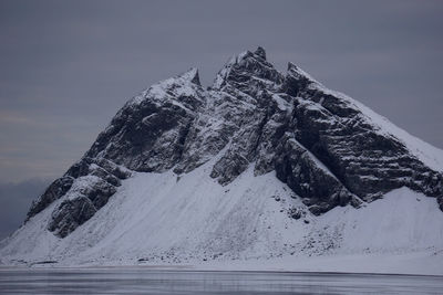 Snow on mountain against sky during winter