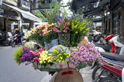 Pink flowers on plant by street in city