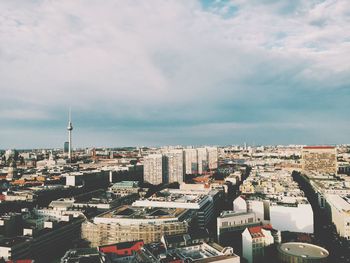 Cityscape against cloudy sky