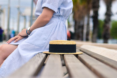 Midsection of woman sitting on bench