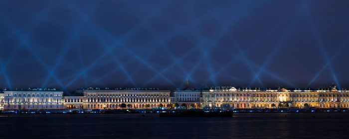 View of illuminated city waterfront at night