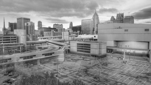 Buildings in city against cloudy sky