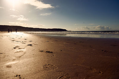 Scenic view of beach against sky during sunset