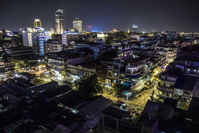 High angle view of illuminated buildings in city at night